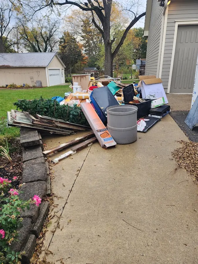 Dumpster being loaded with debris for 12 Yard Dumpster Rental in Dayton